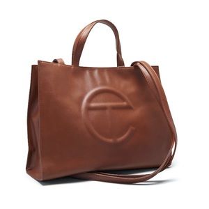 The Telfar Bag Medium Tan is a 10.7-inch tall, 15-inch wide, and 5-inch